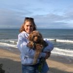 Catherine Auger with dog on the beach