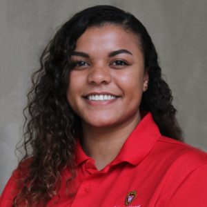 Headshot of Mina House in red ISS polo