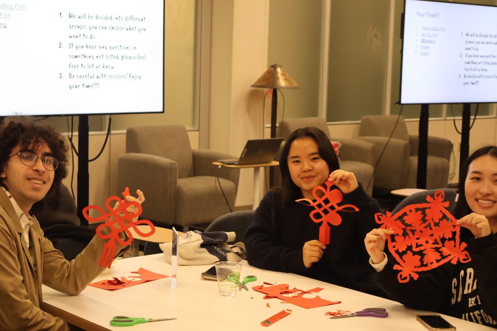 Student attendees pose with their paper cuttings.