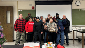 group of people standing together in a classroom