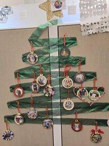*Ribbon tree with pet ornaments put on side of office cubicle, gold, glittery star at top*