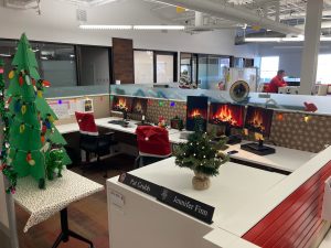 *Office decorations, wooden tree, fireplaces on computer monitors, colorful string lights*