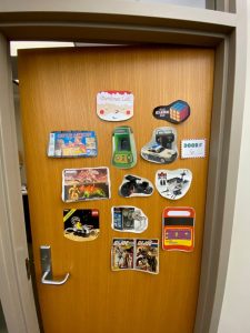 *Door decorated as Christmas list, with images of Rubiks cube, toy cars, legos and more*
