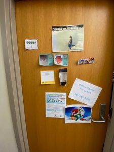 *Door with various messages, image of the Grinch, etc.*