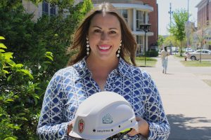 *Image of Jessica holding a hard hat with a Morgridge Hall project sticker on the side*