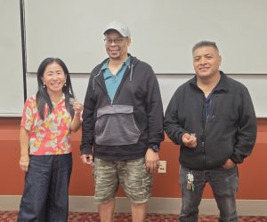 *Three people stand and pose for photo*