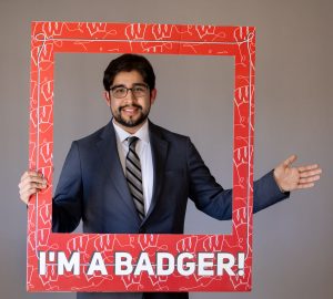 Returning adult student with frame that reads "I'm a Badger."