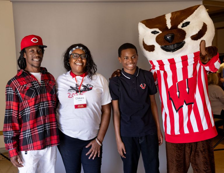 Returning adult student with family and Bucky Badger