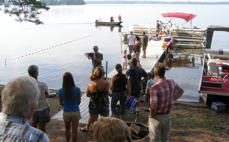 Open house visitors watch as fish are sampled using Fyke nets