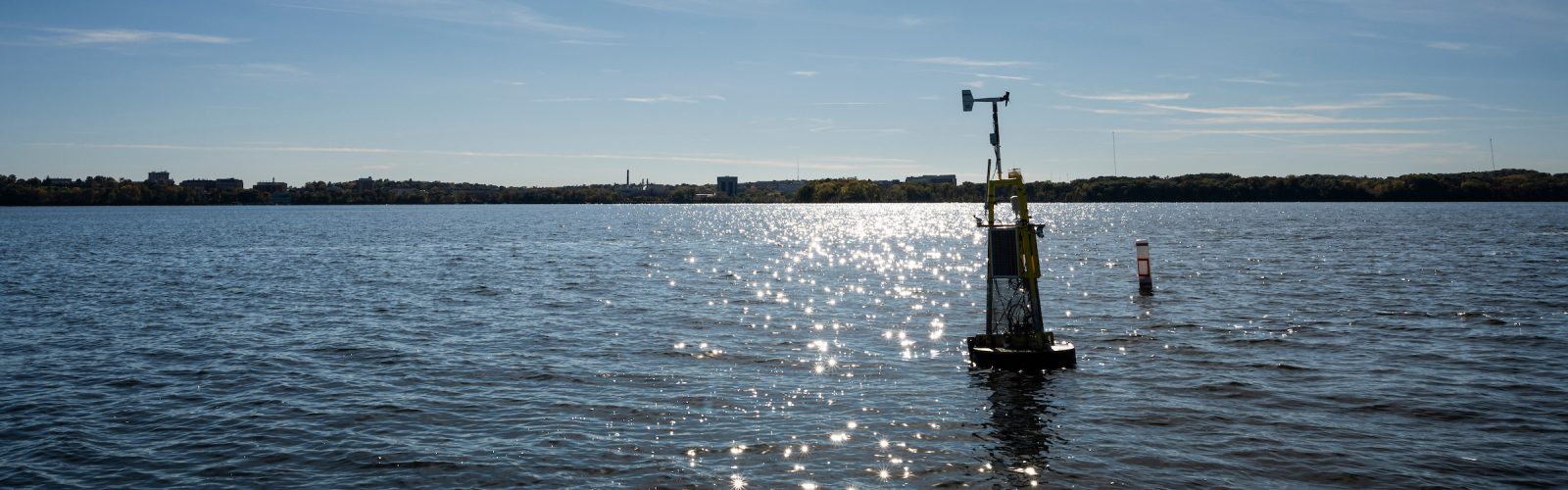 An anchored weather buoy, managed by the UW–Madison Department of Limnology and affectionately nicknamed “David Buoy” (after musician and singer David Bowie) floats above one of the deeper sections of Lake Mendota in Madison, Wis., on a sunny autumn day on Oct. 16, 2024. The buoy has a weather station on top plus records underwater temperature, dissolved oxygen, conductivity and algae levels.