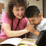 Julie Gamradt reading with a CASC participant