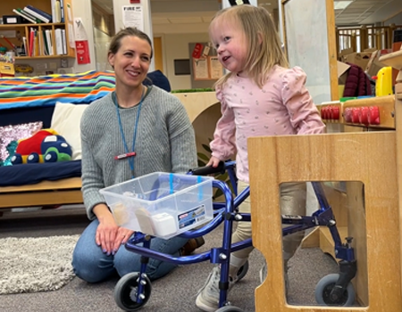 Girl using walker and mom
