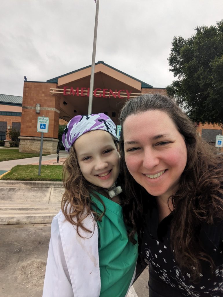 Young girl and mom oustside a school