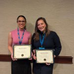 Monica and Olivia holding award certificates