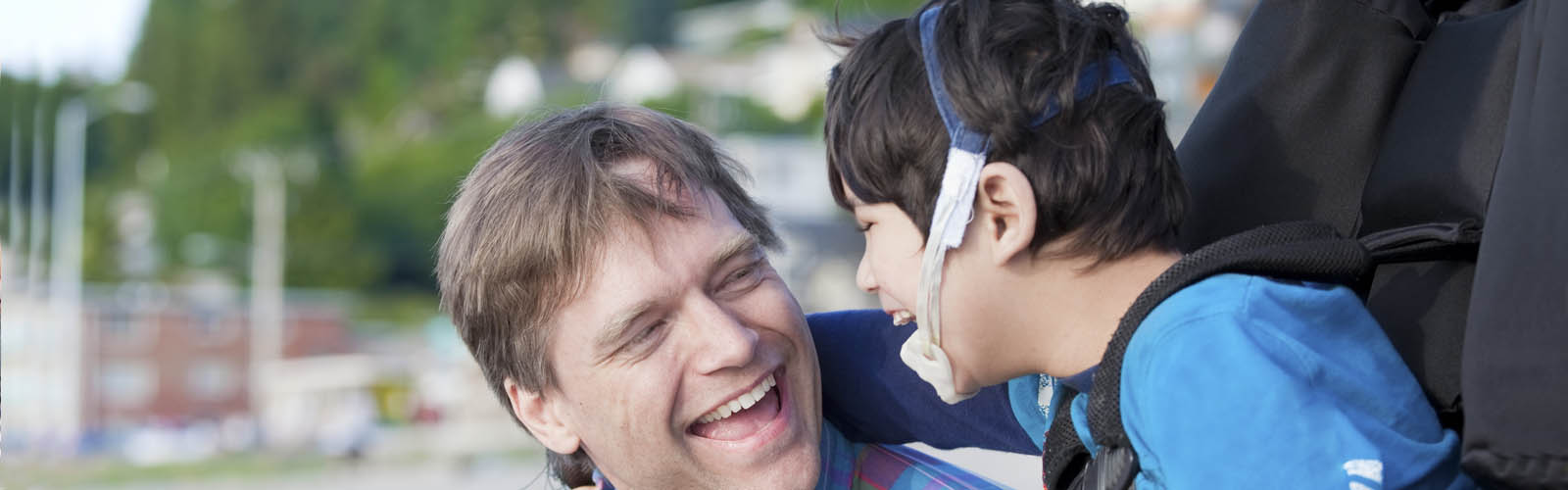 Photo of father with son laughing, March is Developmental Disabilities Awareness Month